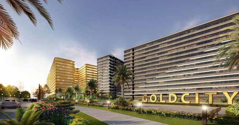 SMDC Gold City: A sleek facade of Gold Residences and Gold Residential-Offices under a clear sky, showcasing modern, glass-clad towers with landscaped surrounds. The Residences feature sunlit windows and varied heights, while the adjacent Offices combine functionality with style, hinting at a bustling community. Both embody luxurious, contemporary urban living.