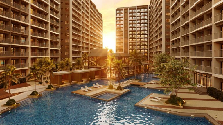 At Sail Residences, indulge in a resort-inspired pool surrounded by lush greenery and contemporary architecture